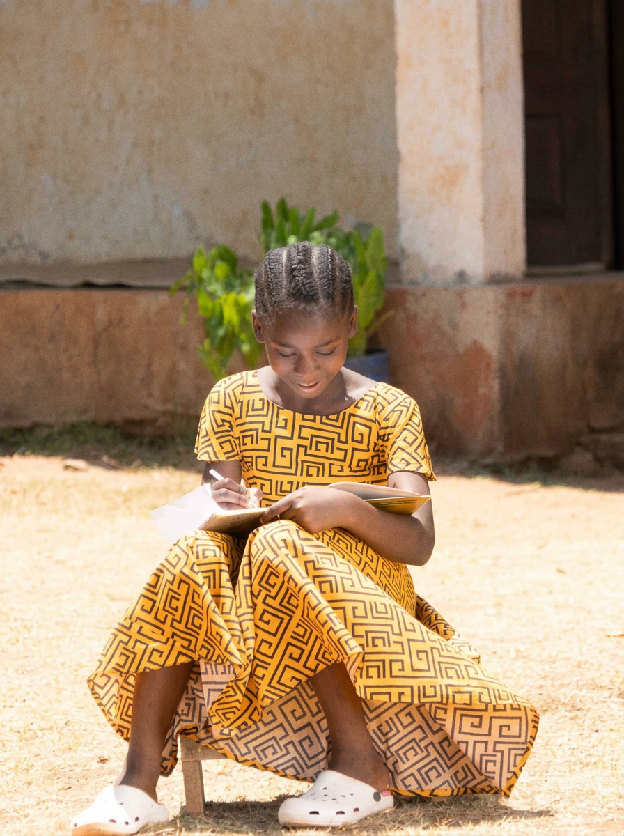 A girl studying outdoors in Tanzania